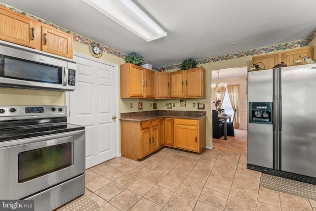 8910 Edison Ln, Clinton, MD 20735 - kitchen featuring appliances with stainless steel finishes, a chandelier, dark countertops, and light tile patterned floors