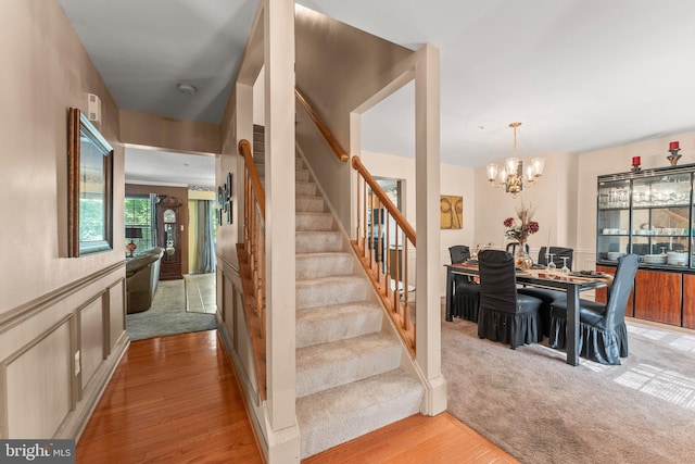 8910 Edison Ln, Clinton, MD 20735 - stairs with wood finished floors and a chandelier