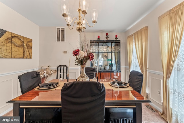 8910 Edison Ln, Clinton, MD 20735 - carpeted dining space featuring a chandelier, a wainscoted wall, and a decorative wall