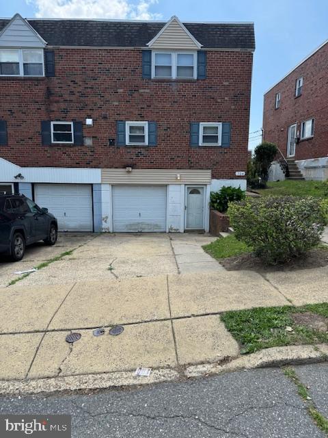 724 Susquehanna Rd, Philadelphia, PA 19111 - view of side of property with an attached garage, driveway, brick siding, and roof with shingles