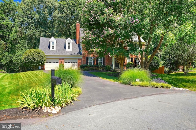 616 Silverstone Ct, Silver Spring, MD 20905 - view of front of house with an attached garage, a front yard, driveway, and brick siding