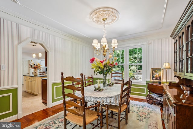 616 Silverstone Ct, Silver Spring, MD 20905 - dining space featuring a chandelier, wood finished floors, ornamental molding, and a decorative wall