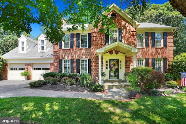 616 Silverstone Ct, Silver Spring, MD 20905 - view of front of home featuring brick siding, an attached garage, a front lawn, driveway, and a shingled roof