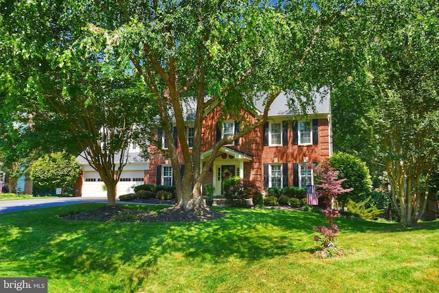 616 Silverstone Ct, Silver Spring, MD 20905 - colonial-style house with asphalt driveway, a front lawn, and brick siding