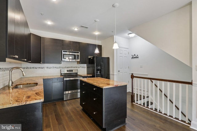 605 N 12th St Unit B, Philadelphia, PA 19123 - kitchen with appliances with stainless steel finishes, dark wood finished floors, tasteful backsplash, and light stone counters