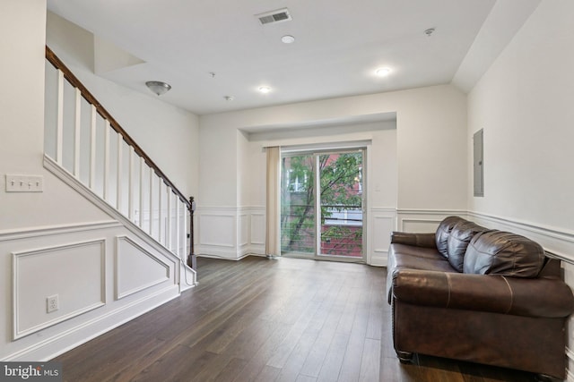 605 N 12th St Unit B, Philadelphia, PA 19123 - living room with stairs, dark wood-style flooring, a decorative wall, wainscoting, and electric panel
