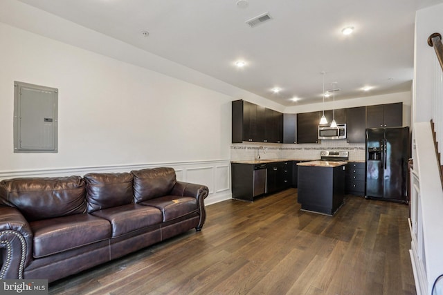 605 N 12th St Unit B, Philadelphia, PA 19123 - kitchen with appliances with stainless steel finishes, electric panel, open floor plan, a center island, and dark wood-style floors