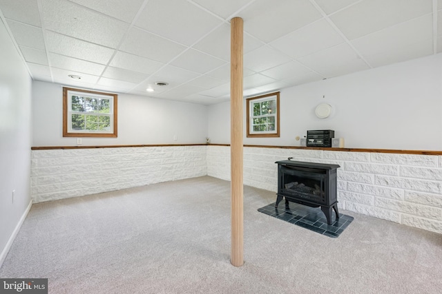 112 Tennessee Trl, Browns Mills, NJ 08015 - basement with a wood stove, a paneled ceiling, and carpet