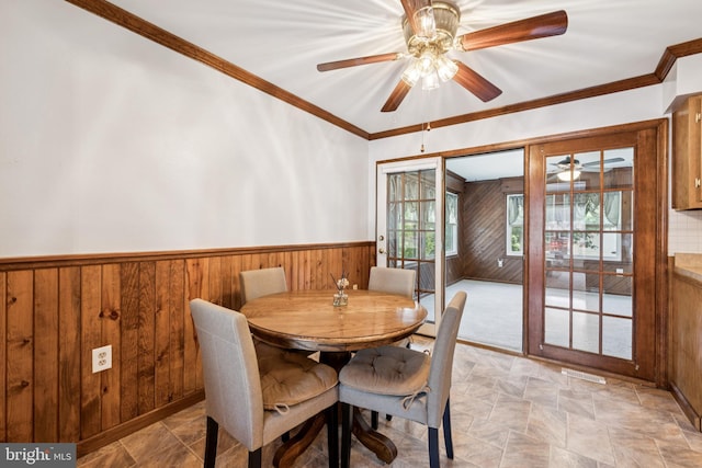 112 Tennessee Trl, Browns Mills, NJ 08015 - dining area with wooden walls, ceiling fan, wainscoting, crown molding, and stone finish flooring