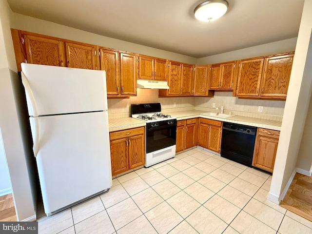 868 Quince Orchard Blvd Unit 202, Gaithersburg, MD 20878 - kitchen with freestanding refrigerator, black dishwasher, gas range oven, under cabinet range hood, and tasteful backsplash