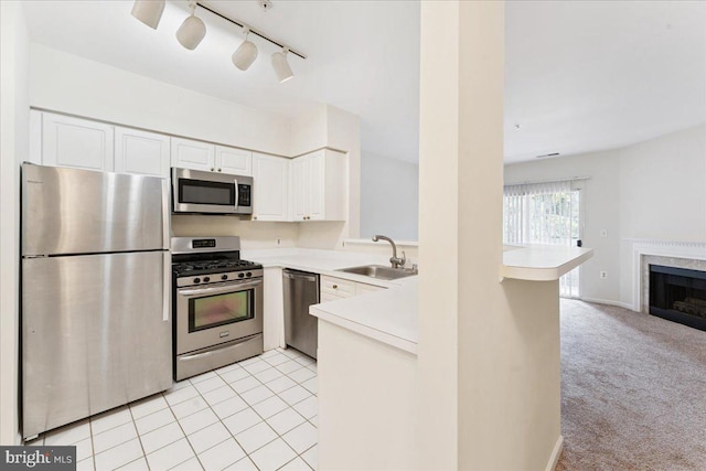 12919 Alton Sq Unit 116, Herndon, VA 20170 - kitchen with appliances with stainless steel finishes, light countertops, open floor plan, and white cabinetry