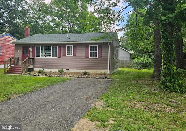 244 6th St, Colonial Beach, VA 22443 - view of front facade with roof with shingles, crawl space, driveway, and a chimney