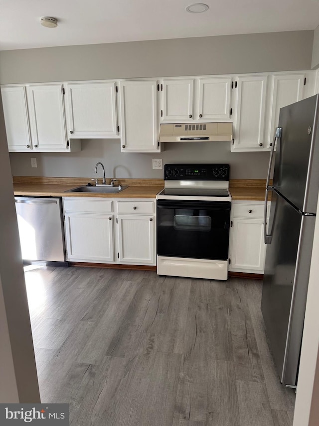 11450 Fruitwood Way Unit 92, Germantown, MD 20876 - kitchen with stainless steel appliances, under cabinet range hood, white cabinetry, and wood finished floors