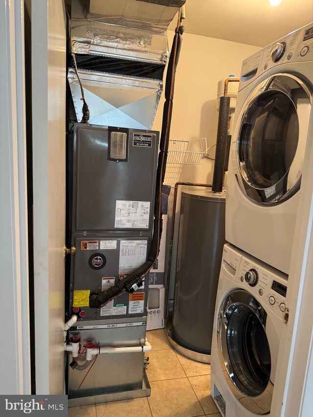 11450 Fruitwood Way Unit 92, Germantown, MD 20876 - laundry room featuring stacked washing machine and dryer, tile patterned flooring, and water heater