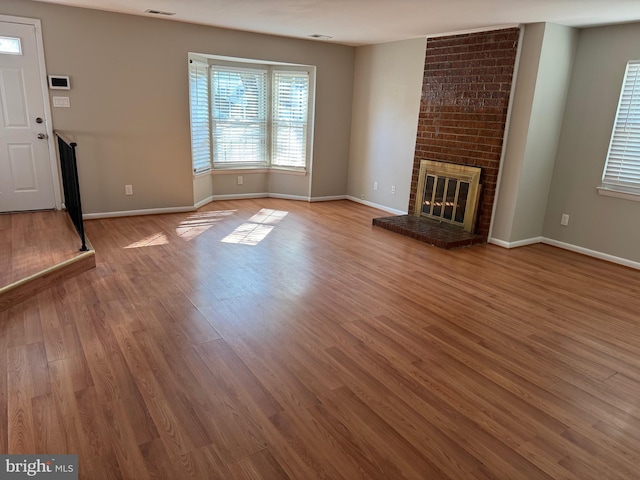 11450 Fruitwood Way Unit 92, Germantown, MD 20876 - unfurnished living room featuring a brick fireplace and wood finished floors