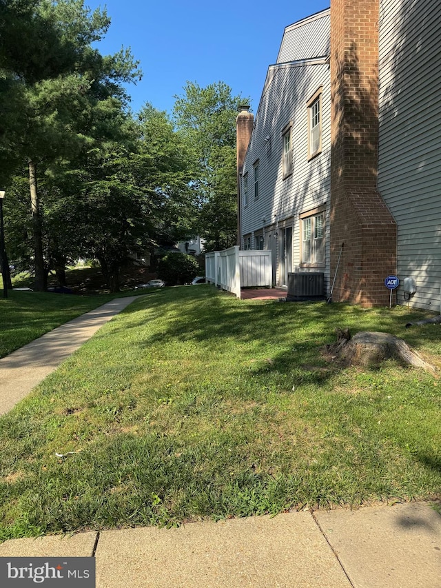 11450 Fruitwood Way Unit 92, Germantown, MD 20876 - view of property exterior featuring a chimney and a yard