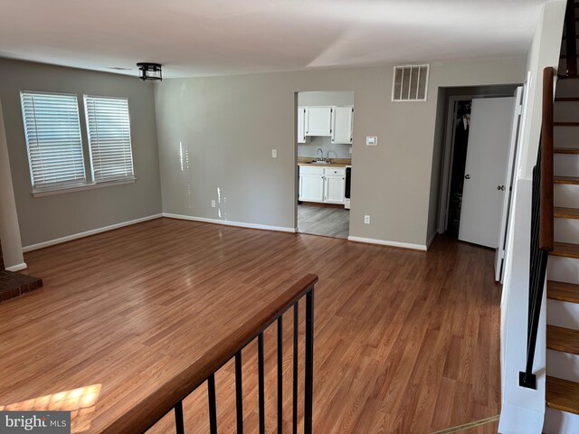 11450 Fruitwood Way Unit 92, Germantown, MD 20876 - unfurnished living room featuring stairway and wood finished floors