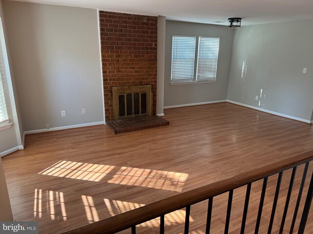 11450 Fruitwood Way Unit 92, Germantown, MD 20876 - unfurnished living room with wood finished floors and a brick fireplace