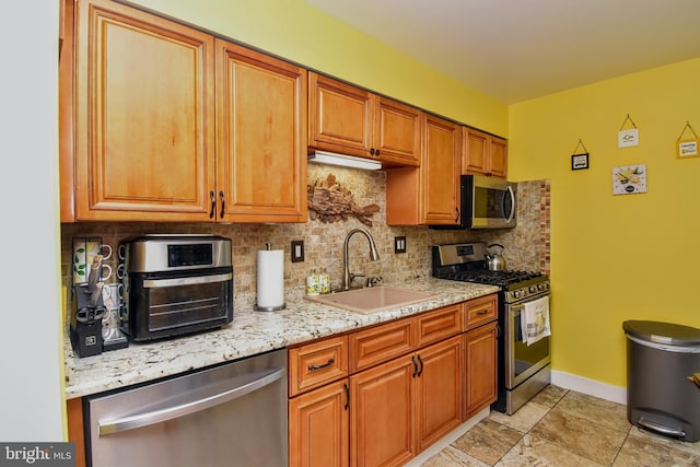 24 Haddon Rd, Somers Point, NJ 08244 - kitchen with stainless steel appliances, tasteful backsplash, brown cabinets, and light stone countertops