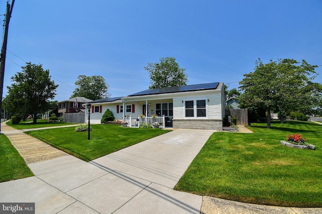 24 Haddon Rd, Somers Point, NJ 08244 - ranch-style house with covered porch, roof mounted solar panels, stone siding, and driveway