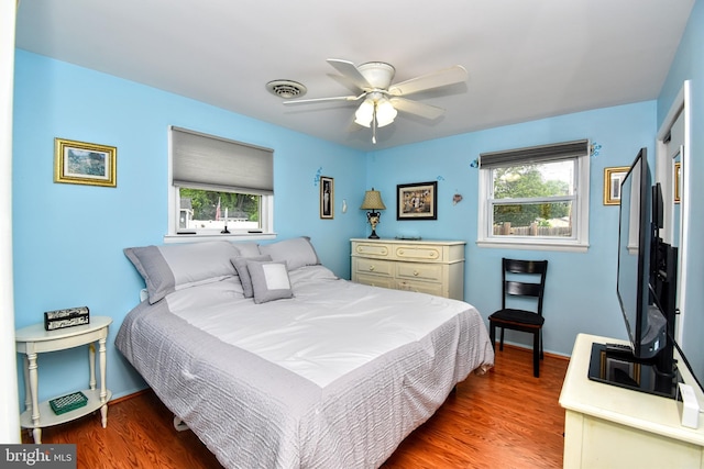 24 Haddon Rd, Somers Point, NJ 08244 - bedroom with multiple windows, wood finished floors, and ceiling fan
