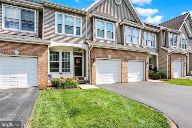 14 Wyomissing Ct, Wyomissing, PA 19610 - view of property featuring driveway, an attached garage, brick siding, and a front yard