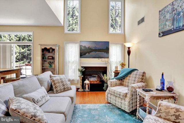14 Wyomissing Ct, Wyomissing, PA 19610 - living area featuring a fireplace with flush hearth, wood finished floors, and a high ceiling