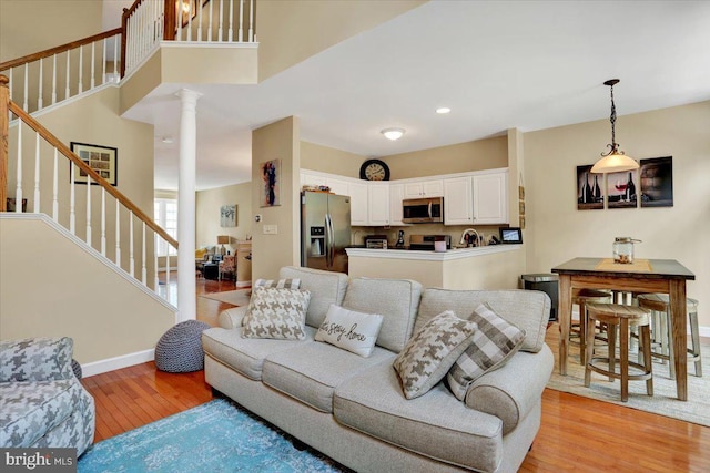 14 Wyomissing Ct, Wyomissing, PA 19610 - living room with decorative columns, light wood-style floors, stairs, and recessed lighting