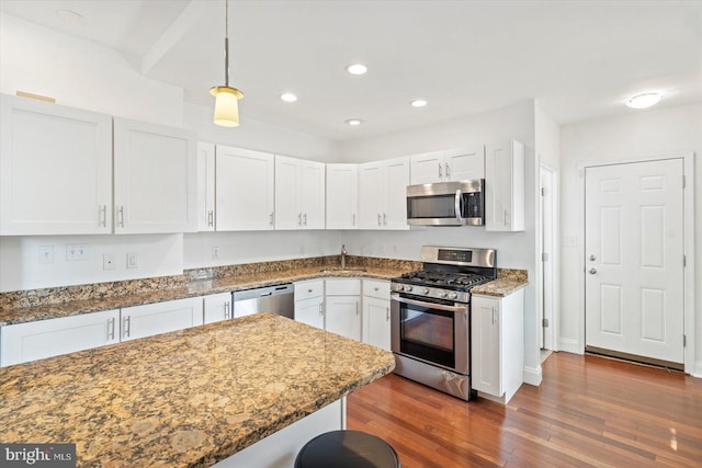 3612 Fait Ave, Baltimore, MD 21224 - kitchen featuring stainless steel appliances, dark wood-type flooring, white cabinets, stone counters, and hanging light fixtures