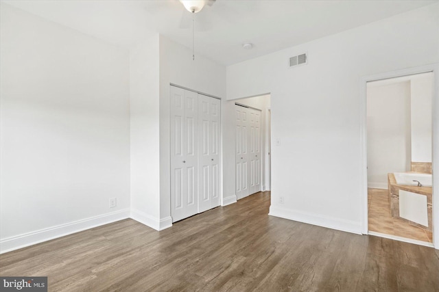 3612 Fait Ave, Baltimore, MD 21224 - unfurnished bedroom featuring wood finished floors and two closets