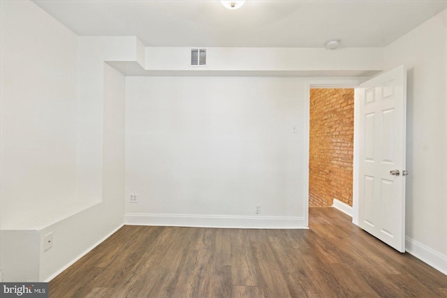 3612 Fait Ave, Baltimore, MD 21224 - unfurnished room with brick wall, wood finished floors, and a smoke detector