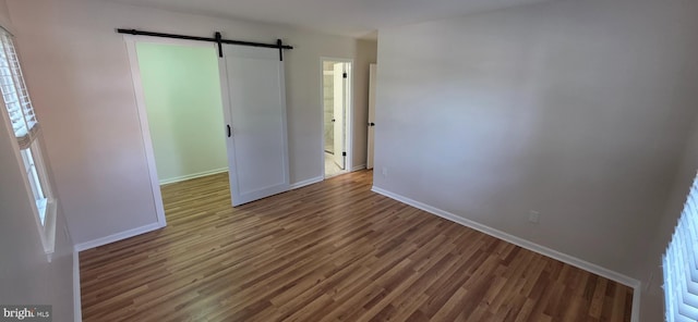 3478 Pence Ct, Annandale, VA 22003 - spare room with a barn door and wood finished floors