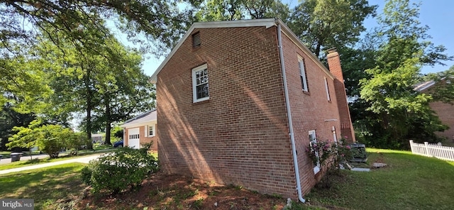 3478 Pence Ct, Annandale, VA 22003 - view of home's exterior featuring brick siding, a garage, a chimney, and driveway