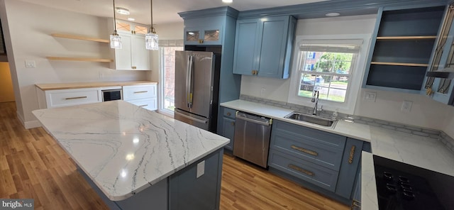 3478 Pence Ct, Annandale, VA 22003 - kitchen featuring stainless steel appliances, open shelves, a kitchen island, and light wood finished floors