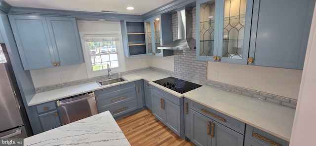 3478 Pence Ct, Annandale, VA 22003 - kitchen featuring wall chimney exhaust hood, appliances with stainless steel finishes, light wood-style flooring, glass insert cabinets, and backsplash