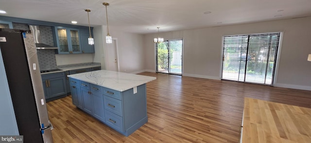 3478 Pence Ct, Annandale, VA 22003 - kitchen featuring freestanding refrigerator, light wood-style flooring, black electric stovetop, blue cabinetry, and open floor plan