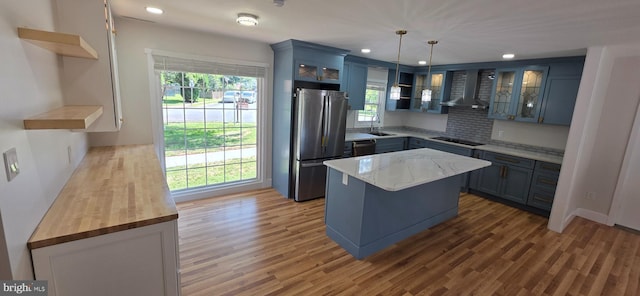 3478 Pence Ct, Annandale, VA 22003 - kitchen with open shelves, freestanding refrigerator, wall chimney exhaust hood, healthy amount of natural light, and recessed lighting