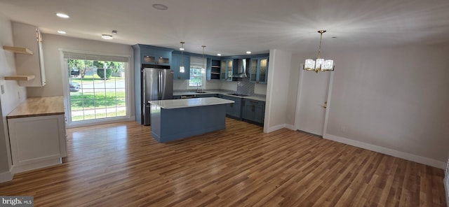 3478 Pence Ct, Annandale, VA 22003 - kitchen featuring open shelves, freestanding refrigerator, wall chimney range hood, wood finished floors, and recessed lighting
