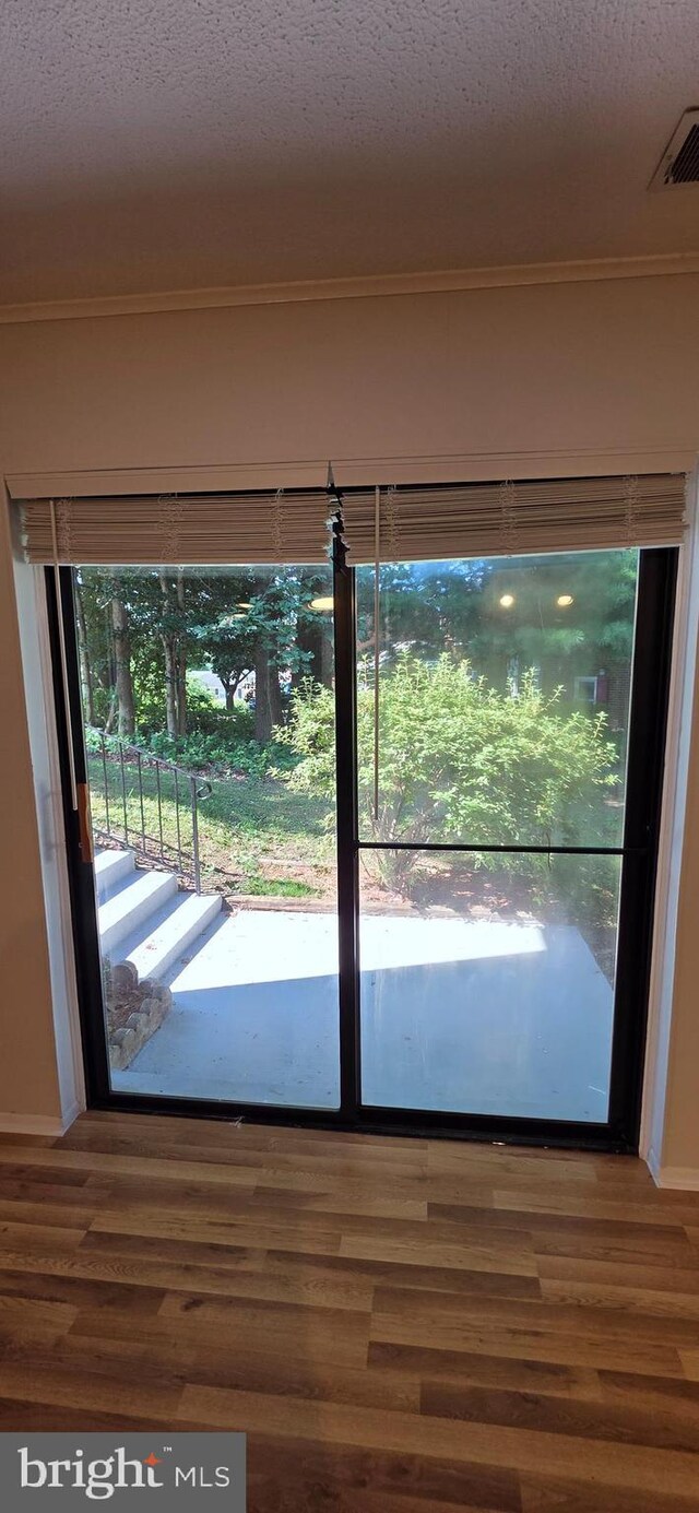 3478 Pence Ct, Annandale, VA 22003 - doorway to outside with wood finished floors, ornamental molding, and a textured ceiling