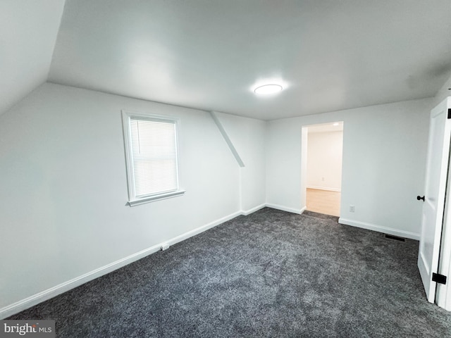 7 N Stuyvesant Dr, Wilmington, DE 19809 - additional living space featuring dark colored carpet and vaulted ceiling