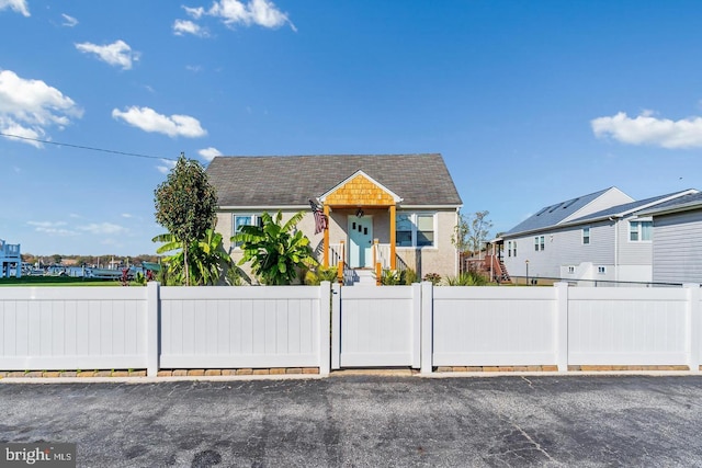 6934 River Drive Rd, Sparrows Point, MD 21219 - view of front facade with a fenced front yard, stucco siding, and a gate