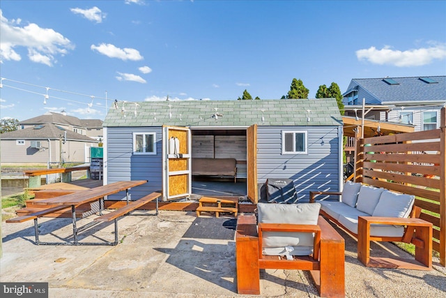 6934 River Drive Rd, Sparrows Point, MD 21219 - back of property featuring an outdoor hangout area, a patio area, an outdoor structure, and a shingled roof
