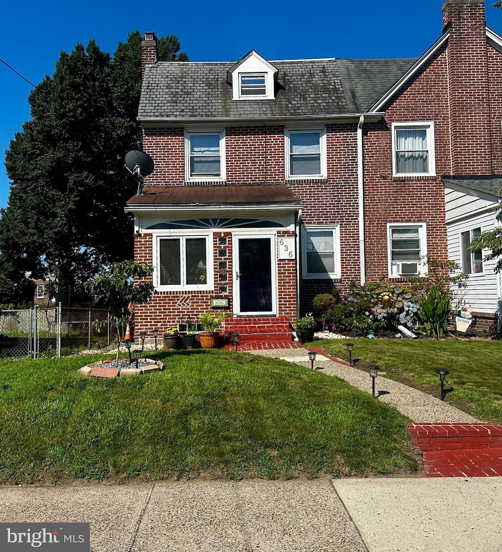 636 W 31st St, Wilmington, DE 19802 - view of front of house featuring a chimney, brick siding, entry steps, and cooling unit