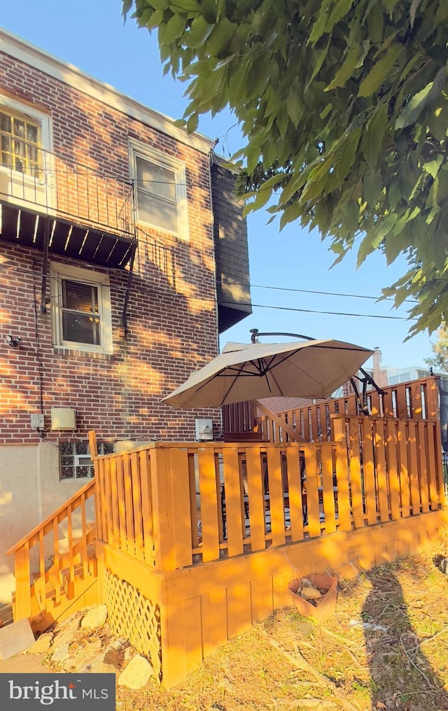 636 W 31st St, Wilmington, DE 19802 - view of side of home with brick siding and a wooden deck