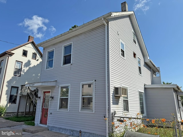 507 Market St, New Cumberland, PA 17070 - back of property featuring an AC wall unit and a chimney