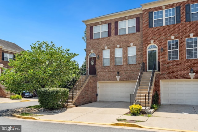 8562 Wyngate Manor Ct, Alexandria, VA 22309 - view of property featuring stairs, brick siding, driveway, and a garage
