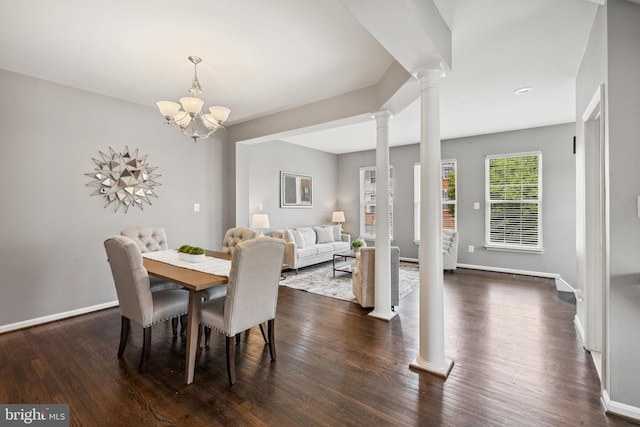 8562 Wyngate Manor Ct, Alexandria, VA 22309 - dining room with decorative columns, dark wood-style flooring, and a chandelier