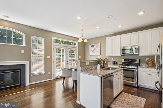 8562 Wyngate Manor Ct, Alexandria, VA 22309 - kitchen featuring appliances with stainless steel finishes, dark wood-style floors, white cabinets, a kitchen island with sink, and recessed lighting
