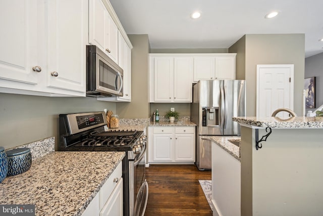 8562 Wyngate Manor Ct, Alexandria, VA 22309 - kitchen with appliances with stainless steel finishes, white cabinets, recessed lighting, and light stone countertops