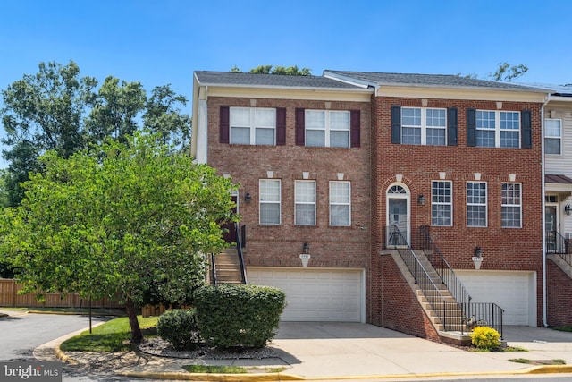 8562 Wyngate Manor Ct, Alexandria, VA 22309 - view of property with stairs, a garage, and brick siding